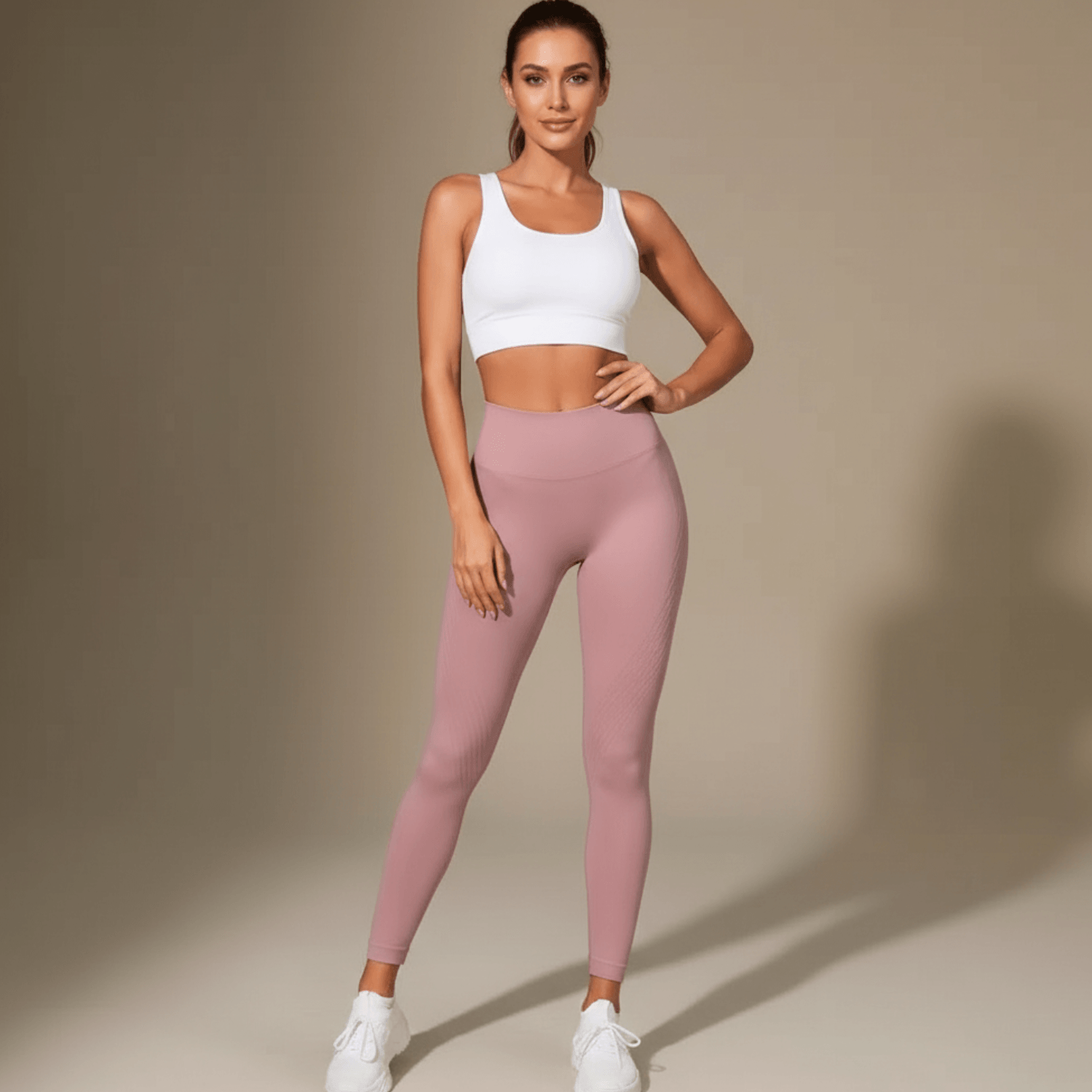 Legging anti cellulite femme rose poudré vue de face avec visage visible en studio beige minimaliste